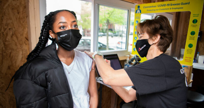 A nurse practitioner named Heidi Johnson administers a vaccine from Johnson & Johnson